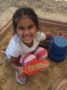 preschool_girl_digging_in_sand_on_playground_at_next_generation_childrens_centers_franklin_ma-336x450