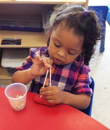 preschool_girl_doing_cheerio_activity_at_cadence_academy_preschool_northeast_columbia_sc-382x450