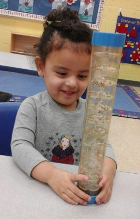 preschool_girl_enjoying_bead_toy_prime_time_early_learning_centers_east_rutherford_nj-289x450