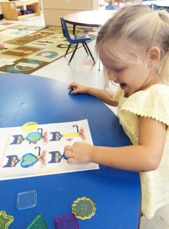 preschool_girl_enjoying_button_cat_activity_cadence_academy_preschool_myrtle_beach_sc-333x450