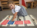 preschool_girl_enjoying_letter_activity_smaller_scholars_montessori_academy_grisby_tx-600x450