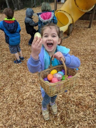 preschool_girl_excited_about_easter_egg_cadence_academy_preschool_tacoma_wa-338x450