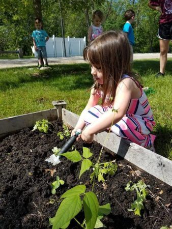 preschool_girl_gardening_outside_jonis_child_care_preschool_burlington_ct-338x450