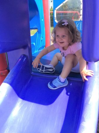 preschool_girl_going_down_slide_at_next_generation_childrens_centers_hopkinton_ma-336x450