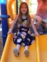 preschool_girl_going_down_slide_on_playground_at_next_generation_childrens_centers_andover_ma-338x450