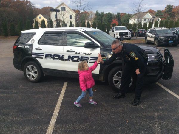 preschool_girl_high_fiving_policeman_at_next_generation_childrens_centers_walpole_ma-600x450