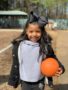 preschool_girl_holding_a_kickball_on_the_playground_sunbrook_academy_at_legacy_park-338x450