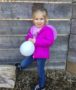 preschool_girl_holding_balloon_on_playground_at_cadence_academy_preschool_westerly_ri-380x450