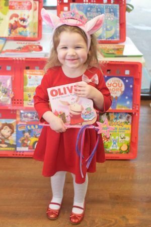 preschool_girl_holding_olivia_book_cadence_academy_preschool_mauldin_sc-300x450