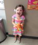 preschool_girl_holding_orange_dinosaur_cadence_academy_preschool_johnston_ia-377x450