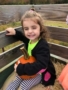 preschool_girl_holding_pumpkin_on_hay_ride_cadence_academy_preschool_east_greenwich_ri-338x450