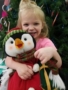 preschool_girl_hugging_penguin_stuffed_animal_at_the_peanut_gallery_la_porte_tx-338x450