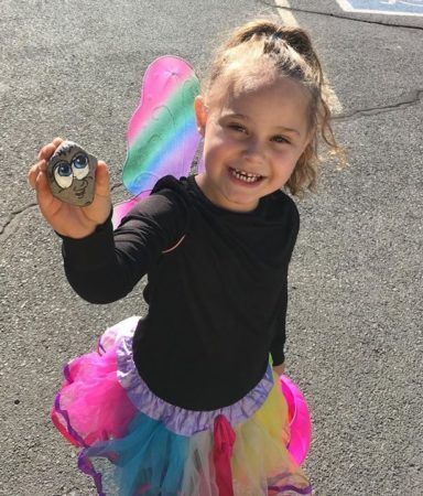 preschool_girl_in_butterfly_wings_showing_painted_rock_miss_muffets_learning_center_klamath_falls_or-384x450