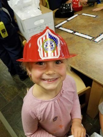 preschool_girl_in_firefighter_hat_cadence_academy_preschool_childrens_center_klamath_falls_or-338x450