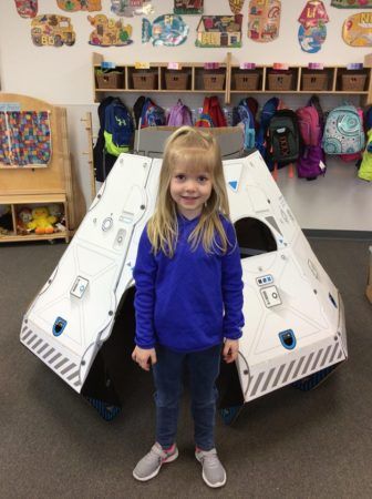 preschool_girl_in_front_of_space_capsule_adventures_in_learning_oswego_il-336x450