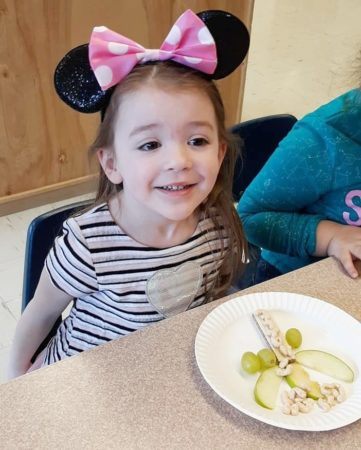 preschool_girl_in_minnie_mouse_ears_eating_healthy_snack_prime_time_early_learning_centers_east_rutherford_nj-361x450