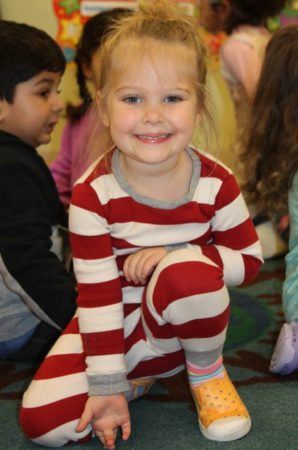 preschool_girl_in_pajamas_smiling_for_camera_at_learning_edge_childcare_and_preschool_new_berlin_wi-298x450