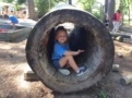 preschool_girl_inside_hollowed_out_log_creative_expressions_learning_center_eureka_mo-603x450