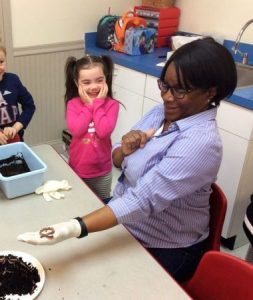 preschool_girl_laughing_with_teacher_about_worm_winwood_childrens_center_gainesville_va-380x450