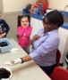 preschool_girl_laughing_with_teacher_about_worm_winwood_childrens_center_gainesville_va-380x450