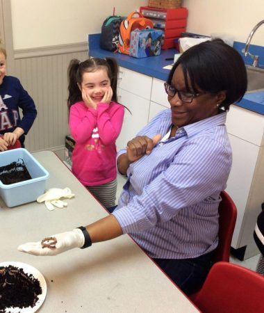 preschool_girl_laughing_with_teacher_about_worm_winwood_childrens_center_gainesville_va-380x450