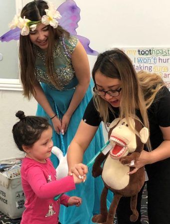 preschool_girl_learning_how_to_brush_teeth_cadence_academy_preschool_flower_mound_tx-341x450