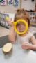 preschool_girl_looking_through_magnifying_glass_jonis_child_care_preschool_canton_ct-261x450