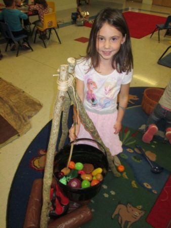 preschool_girl_making_stone_soup_cadence_academy_ballantyne_charlotte_nc-338x450