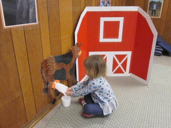 preschool_girl_milking_cow_cadence_academy_preschool_urbandale_ia-600x450