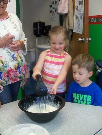 preschool_girl_mixing_batter_creative_kids_childcare_centers_brewster-338x450