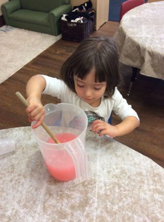 preschool_girl_mixing_lemonade_at_cadence_academy_preschool_columbine_littleton_co-333x450