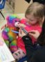 preschool_girl_nursing_rainbow_bear_back_to_health_cadence_academy_preschool_iowa_city_ia-324x450