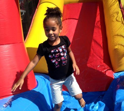 preschool_girl_on_inflatable_slide_cadence_academy_preschool_northeast_columbia_sc-502x450