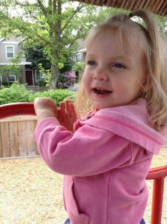 preschool_girl_on_playground_equipment_cadence_academy_preschool_dupont_wa-336x450