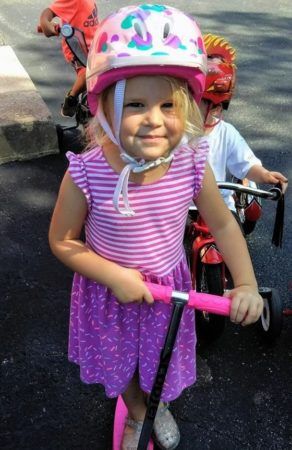 preschool_girl_on_scooter_at_cadence_academy_preschool_franklin_tn-292x450