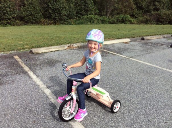 preschool_girl_on_tricycle_cadence_academy_preschool_greensboro_nc-605x450
