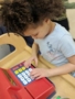 preschool_girl_operating_cash_register_rogys_learning_place_hilltop_peoria_il-338x450