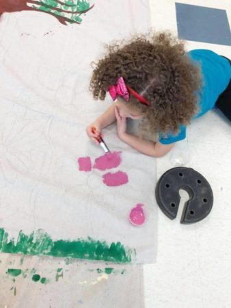 preschool_girl_painting_a_flower_prime_time_early_learning_centers_farmingdale_ny-338x450