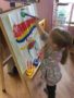 preschool_girl_painting_a_snowman_at_cadence_academy_preschool_norwood_ma-338x450