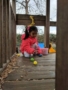 preschool_girl_picking_up_easter_eggs_on_playground_cadence_academy_preschool_tacoma_wa-338x450