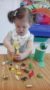 preschool_girl_picking_up_plastic_insects_with_tweezers_prime_time_early_learning_centers_edgewater_nj-248x450