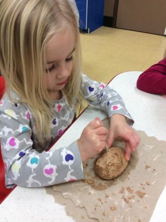 preschool_girl_playing_with_clay_creative_expressions_learning_center_eureka_mo-336x450