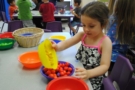 preschool_girl_playing_with_food_phoenix_childrens_academy_private_preschool_lindsay-673x450