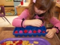 preschool_girl_playing_with_fuzzy_balls_and_ice_cube_tray_cadence_academy_preschool_sherwood_or-600x450
