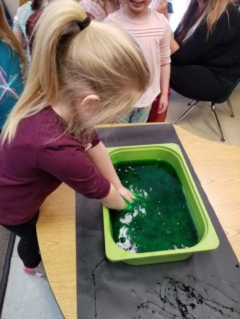 preschool_girl_playing_with_goop_cadence_academy_conshohocken_pa-338x450