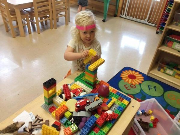 preschool_girl_playing_with_large_legos_cadence_academy_preschool_milwaukie_portland_or-600x450