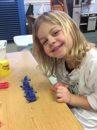 preschool_girl_playing_with_playdough_at_next_generation_childrens_centers_franklin_ma-336x450