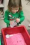 preschool_girl_playing_with_sand_cadence_academy_heartland_clive_ia-300x450