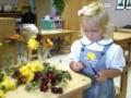 preschool_girl_pruning_flowers_smaller_scholars_montessori_academy_grisby_tx-600x450