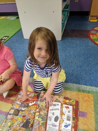 preschool_girl_reading_a_book_creative_kids_childcare_centers_beekman-338x450